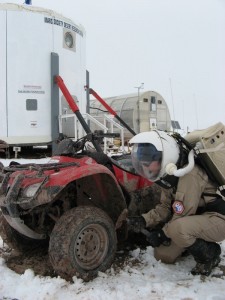 Kiri cleaning mud off the ATV tire